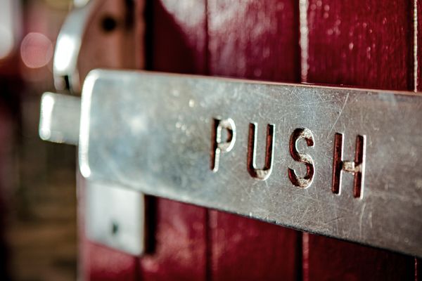 A door helpfully suggests that a push will do the trick. But we probably won't notice that until after we try to pull.
